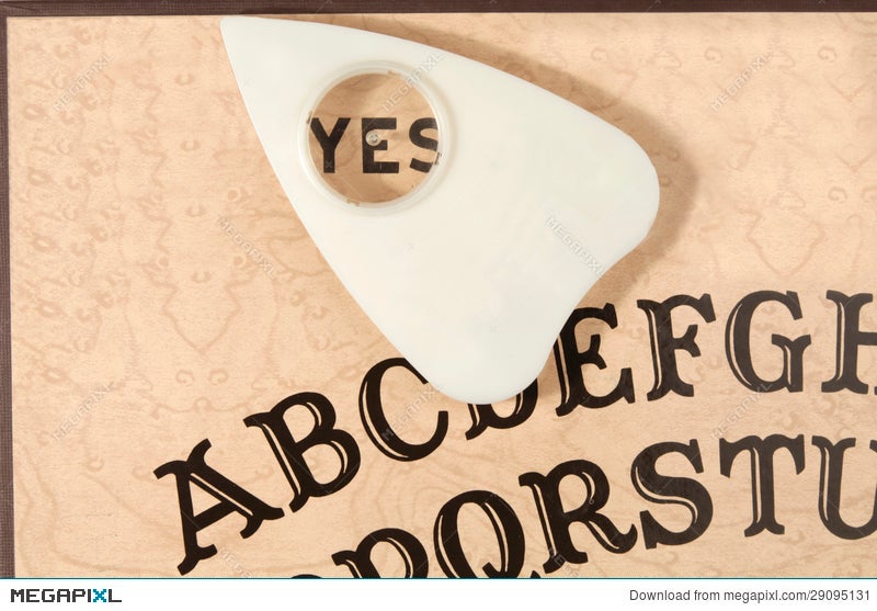 Ouija Board With The Planchette Pointing To Yes Stock Photo