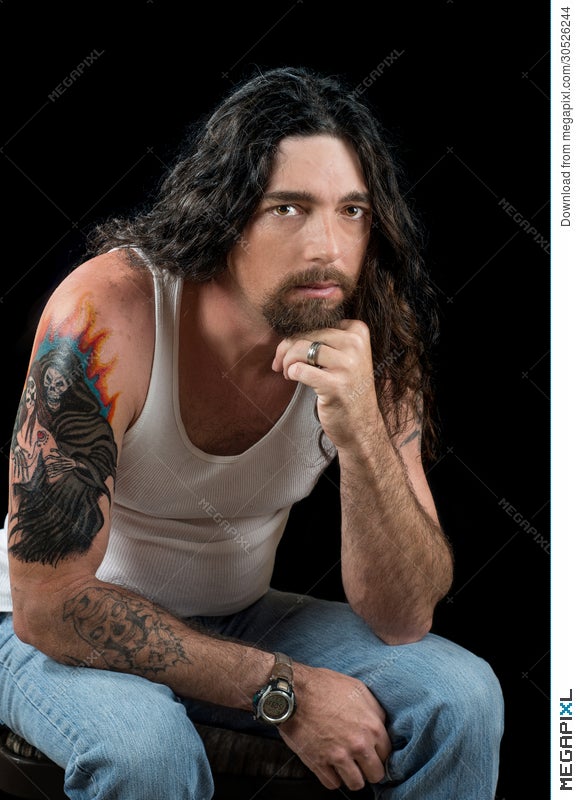 Tough Man With Long Dark Hair And Beautiful Brown Eyes Stock Photo