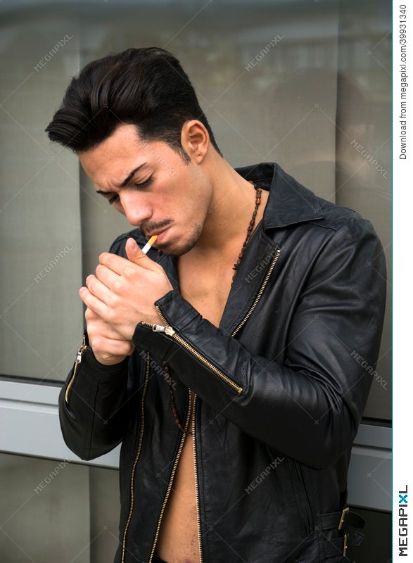Handsome Young Man With Leather Jacket Lighting Up A