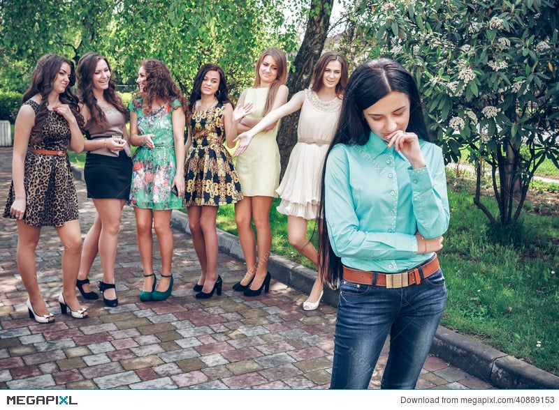 Upset Teenage Girl With Friends Gossiping Stock Photo Megapixl