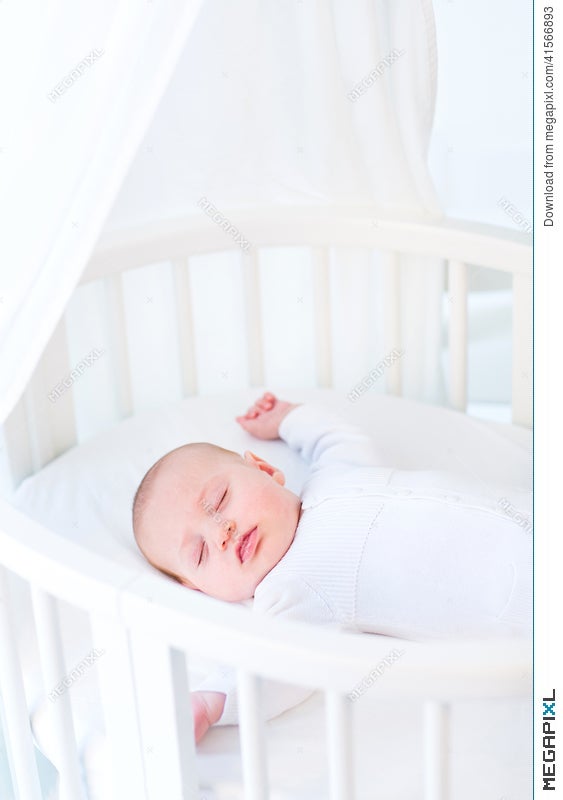 Little Newborn Baby Boy Sleeping In White Round Crib Stock Photo