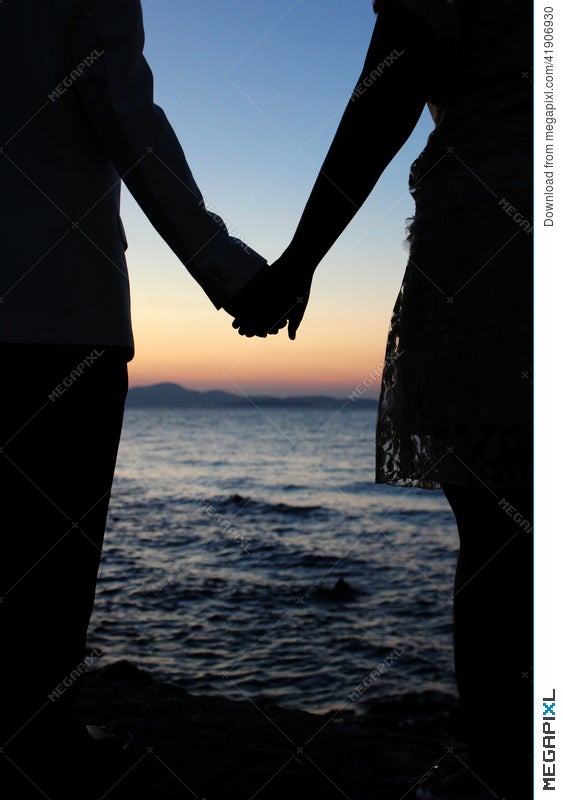 Romantic Silhouette Couple Holding Hands On A Beach In Sunset Stock Photo Megapixl