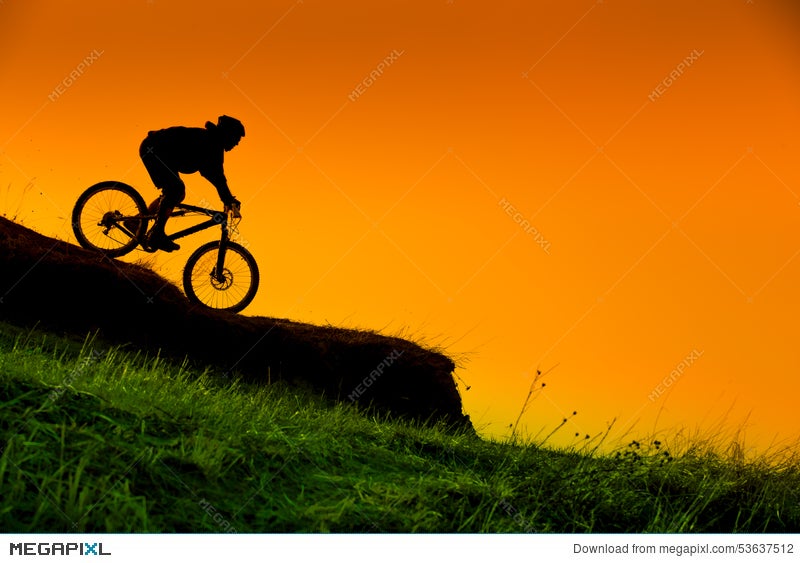 Silhouette Of Downhill Mountain Bike Rider At Sunset Stock Photo Megapixl