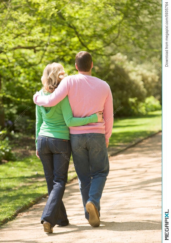 Couple Walking On Path Arm In Arm Stock Photo Megapixl