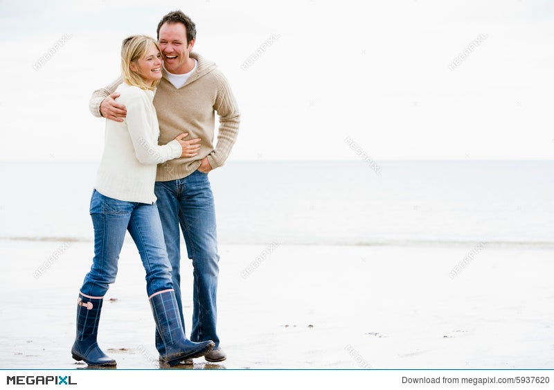 Couple Walking On Beach Arm In Arm Smiling Stock Photo Megapixl