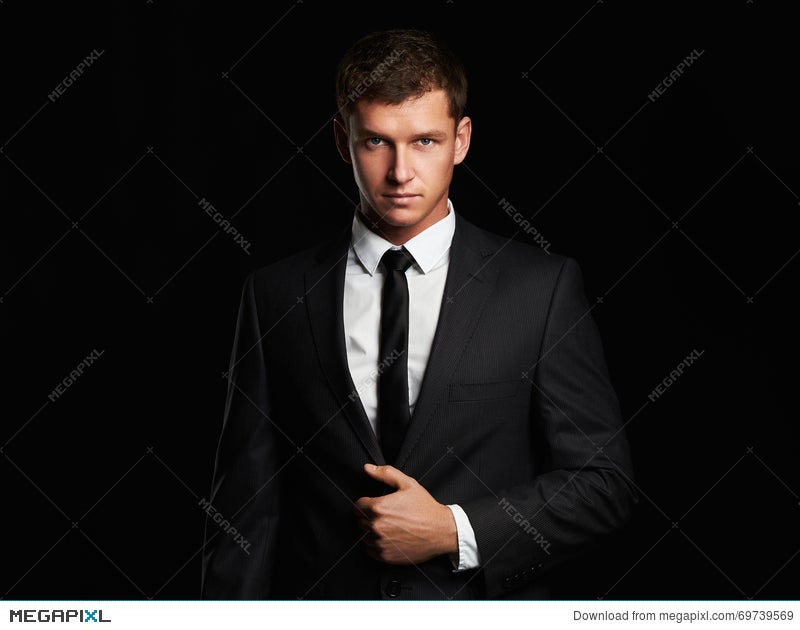 Businessman Standing On Black Background. Handsome Young Man In Suit Stock  Photo 69739569 - Megapixl