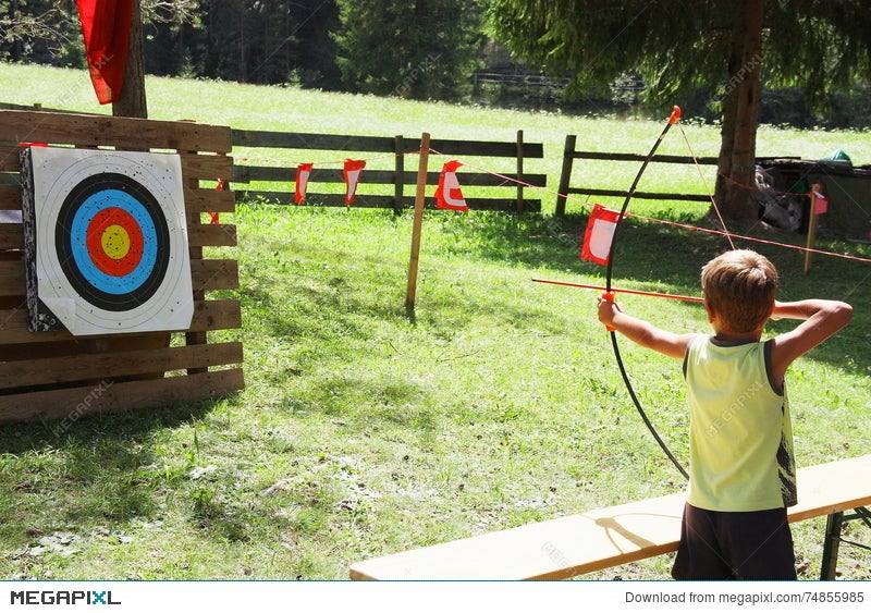 Blond Hair Kid Playing Archery During Children Summer Games Stock