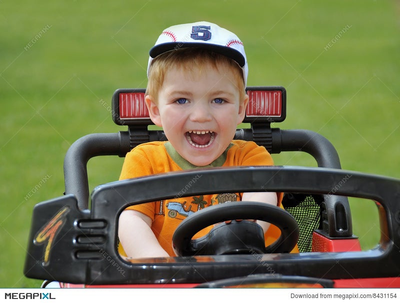 boy driving toy car