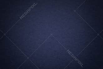 Texture of old navy blue paper background, closeup. Structure of dense cardboard