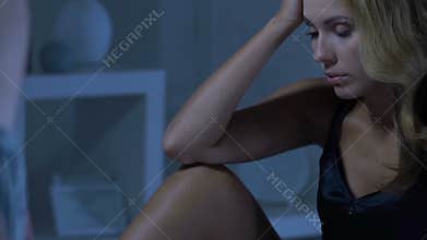 Woman dissatisfied with intimate relations with boyfriend, man looks below waist