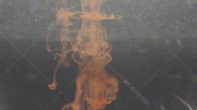 A drop of ink falls into the water. Red. Colorful abstraction.