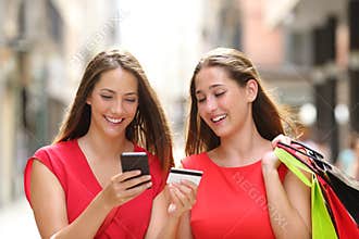 Shoppers buying online with credit card and cellphone
