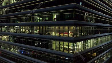 Singapore - 25 September 2018: Close up for exterior of modern office building corner with lighted windows and people
