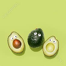 Funny faces avocados on a pastel green background