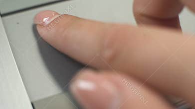 Woman using touchpad on laptop to move pointer and zoom text, images or web-page