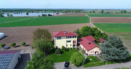 Circling around the farmhouse, around the greenhouse and green fields. European farming, Germany