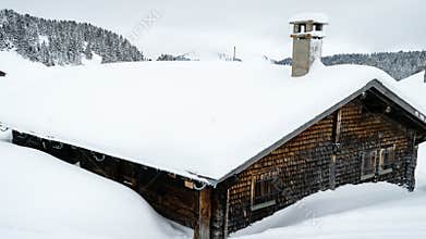Chalet covered with snow in Villars-sur-Ollon in Switzerland, zoom in