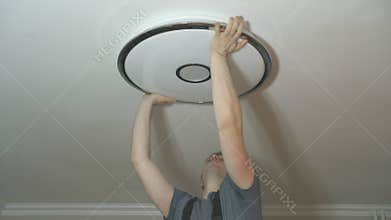 Man mounting LED lamp