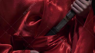 Pulling out a knife in slow motion, close up