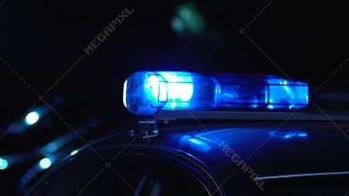 Police car patrolling at night, serving people and protecting neighborhood