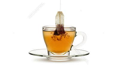 Tea beg infusion into glass cup