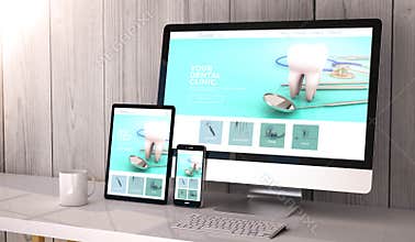 Digital generated devices on desktop, responsive dental clinic website design on screen. All screen graphics are made up. 3d