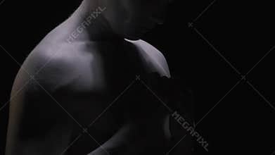 Ancient greek man puts his arms to his chest and looks up