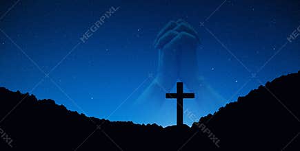 Silhouette of crucifix cross on mountain at night time with hand praying background.