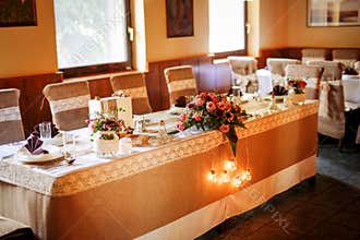 Table setting at a luxury wedding, beautiful orange light