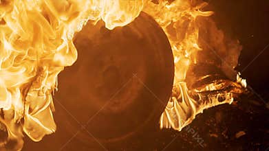 A wheel burns in a car at night, car tires burn, close-up