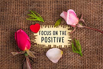 Focus on the positive written in hole on the burlap