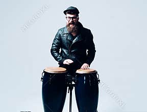 Bearded man. Mature hipster with beard. Male barber care. hipster style. Man in biker leather jacket. Music drums