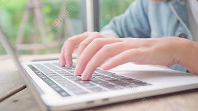 Business freelance Asian woman working, doing projects and sending email on laptop or computer while sitting on table in cafe.