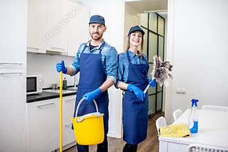 Man and woman as a professional cleaners indoors