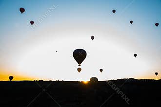 Travel to Goreme, Cappadocia, Turkey. The sunrise in the mountains with a lot of air hot balloons in the sky.