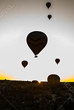 Travel to Goreme, Cappadocia, Turkey. The sunrise in the mountains with a lot of air hot balloons in the sky.