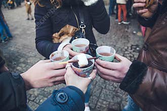 Christmas friends holidays drinking the hot wine with marshmello at the market
