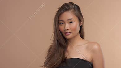 Thai asian model with natural makeup on beige background
