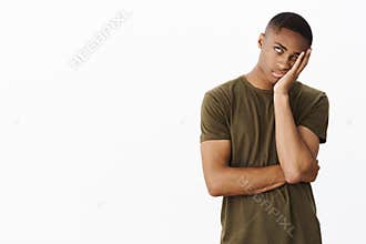 Portrait of annoyed and displeased african american handsome young guy rolling eye up disrespectfully punching face with