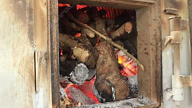 Wood stump in factory stove burning for hot power energy
