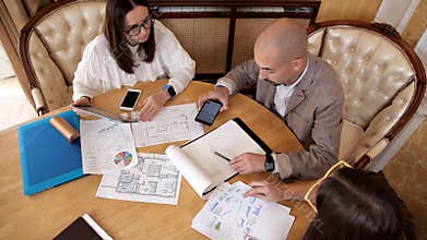 Auditors checking business documents of company, working on laptops, top view