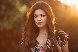 Portrait of a beautiful brunette girl with wavy.