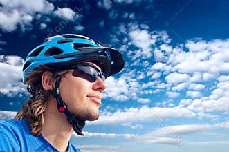 Young bicyclist in helmet and glasses
