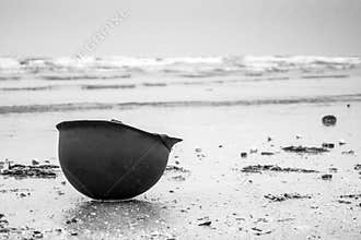 Landing beaches of june 6, 1944 in Normandy. Utah beach. Helmet of a parachutist on the sand. The longest day.