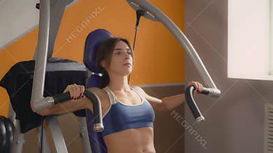 Everyday workout in sport club. Attractive lady.