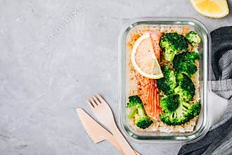 Meal prep lunch box containers with baked salmon fish, rice, green broccoli