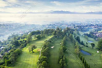 Beautiful golf course with misty Bandung cityscape