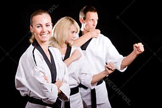 People in kimono make martial arts exercise