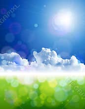 Bright sun, clear skies, clouds, green grass