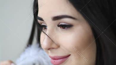 Close up portrait of beautiful woman play with feather near her face